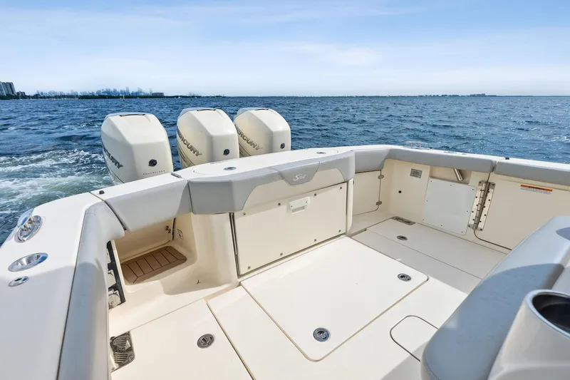 Prime Tyme Yacht Photos Pics 2020 Scout 355 LXF boat deck with triple Mercury engines on open water.