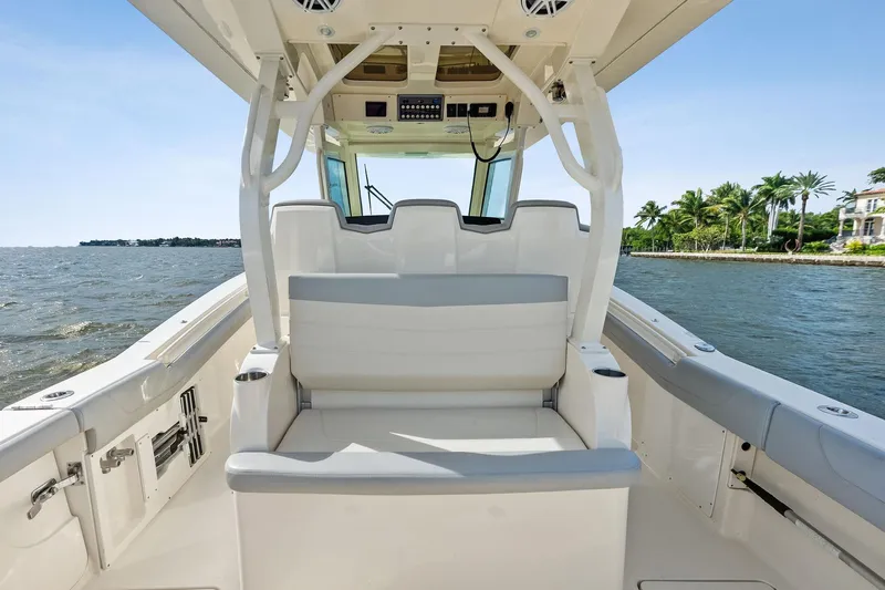 Prime Tyme Yacht Photos Pics 2020 Scout 355 LXF boat interior with seating, ocean view, and palm trees.