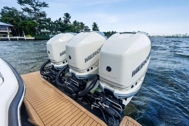 Prime Tyme Yacht Photos Pics Triple Mercury outboard engines on a 2020 Scout 355 LXF boat, docked by the water.