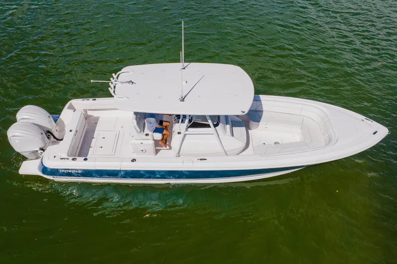  Yacht Photos Pics 2018 Intrepid 327 Center Console boat on green water, aerial view.