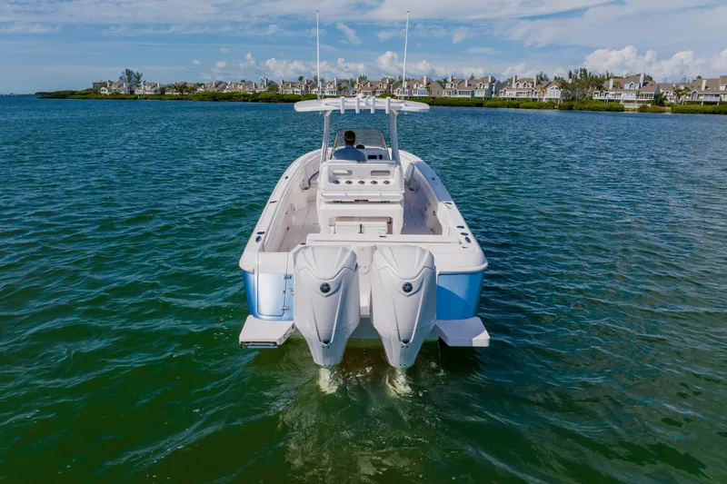  Yacht Photos Pics 2018 Intrepid 327 Center Console boat cruising on a scenic waterway.