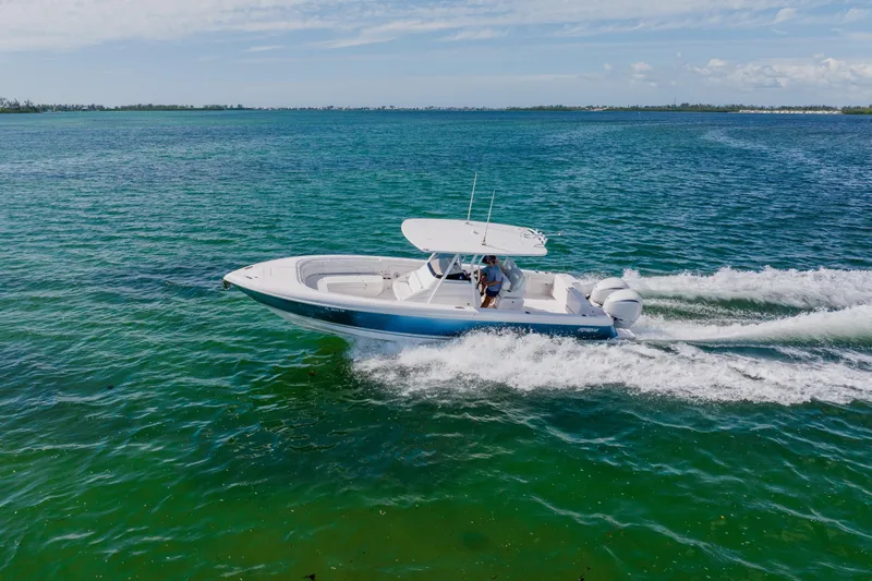  Yacht Photos Pics 2018 Intrepid 327 Center Console boat cruising on clear blue water.
