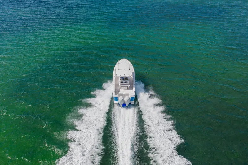  Yacht Photos Pics 2018 Intrepid 327 Center Console boat cruising on open water, aerial view.