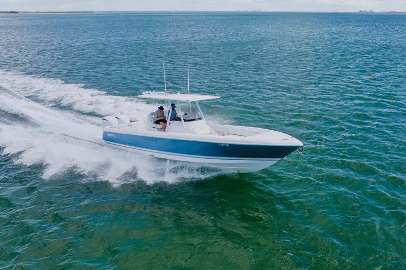  Yacht Photos Pics 2018 Intrepid 327 Center Console boat cruising on open water.