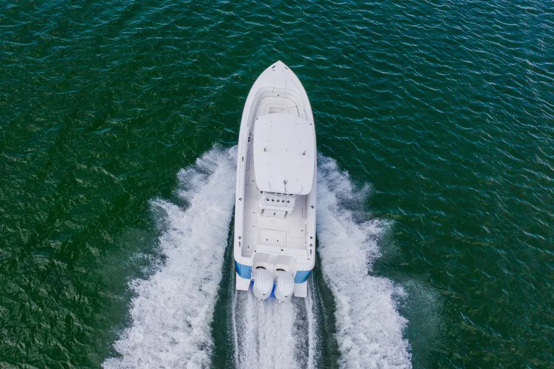  Yacht Photos Pics Aerial view of 2018 Intrepid 327 Center Console boat cruising on open water.