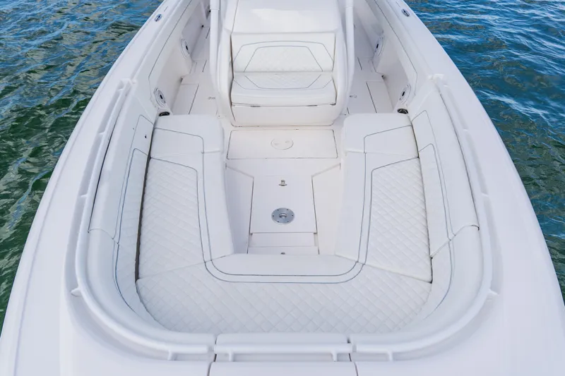 Yacht Photos Pics 2018 Intrepid 327 Center Console boat interior with white cushioned seating on water.