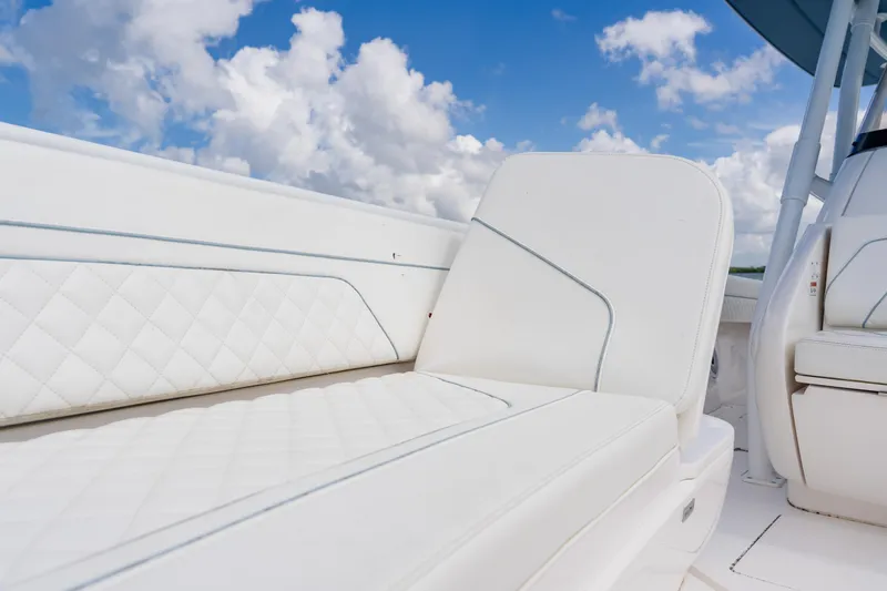  Yacht Photos Pics 2018 Intrepid 327 Center Console boat with luxurious white seating under a blue sky.