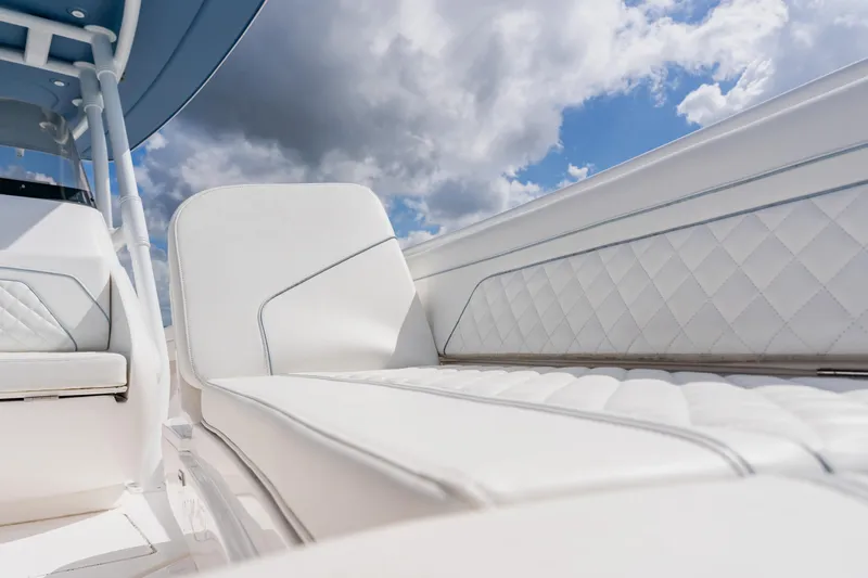 Yacht Photos Pics 2018 Intrepid 327 Center Console with white quilted seating under a cloudy sky.
