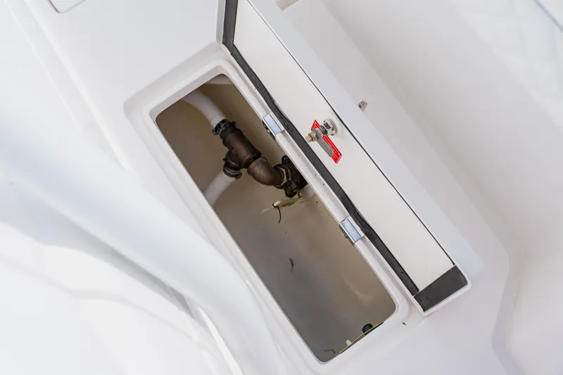  Yacht Photos Pics 2018 Intrepid 327 Center Console boat compartment with visible plumbing and storage.