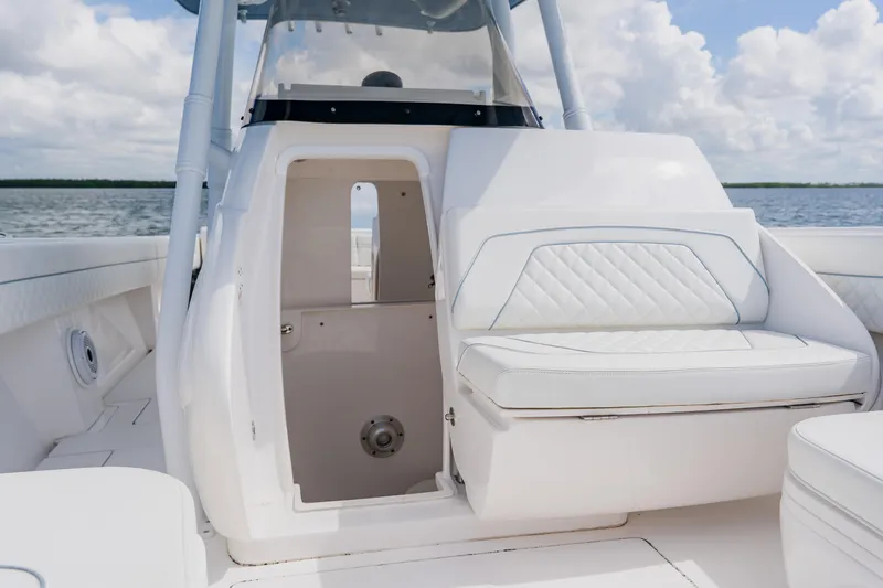  Yacht Photos Pics 2018 Intrepid 327 Center Console interior with white seating and open cabin door.