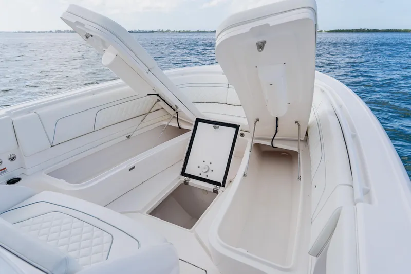  Yacht Photos Pics 2018 Intrepid 327 Center Console boat with open storage compartments on the water.