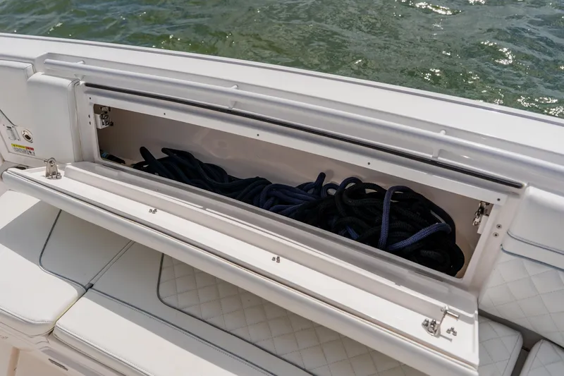  Yacht Photos Pics Open storage compartment on 2018 Intrepid 327 Center Console boat with coiled ropes inside.