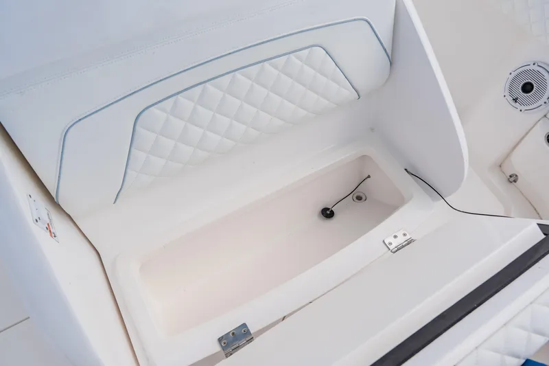  Yacht Photos Pics 2018 Intrepid 327 Center Console boat interior storage compartment with quilted upholstery.