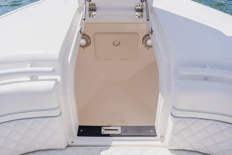  Yacht Photos Pics 2018 Intrepid 327 Center Console boat interior with white seating and storage compartment.