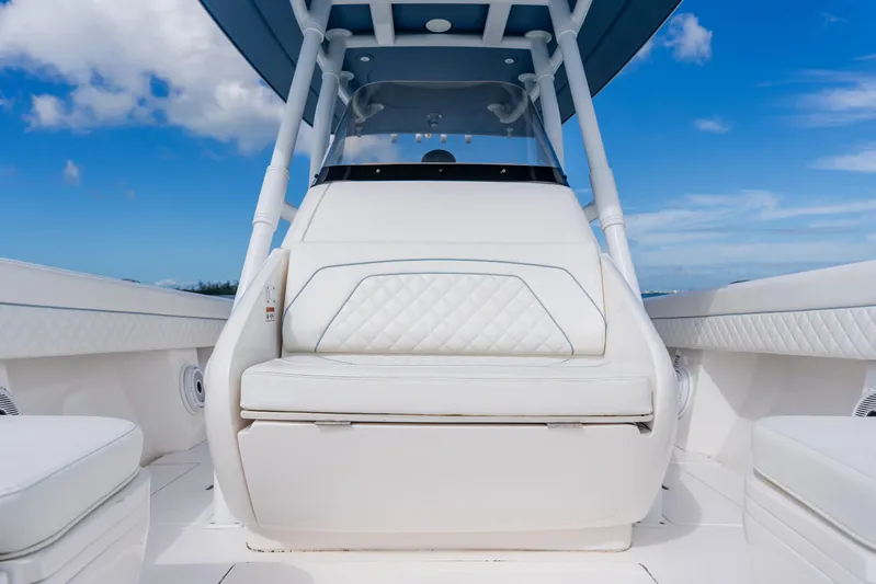  Yacht Photos Pics 2018 Intrepid 327 Center Console boat interior with white seating and blue sky background.