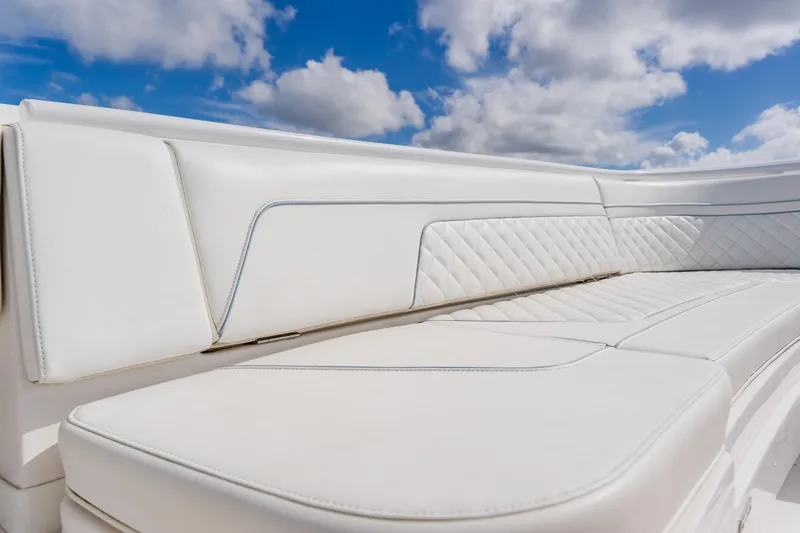  Yacht Photos Pics Luxurious white seating on 2018 Intrepid 327 Center Console boat under blue sky.