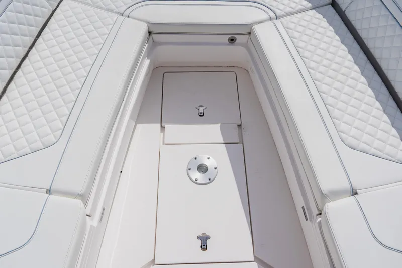  Yacht Photos Pics 2018 Intrepid 327 Center Console boat interior with quilted white seating and storage compartments.