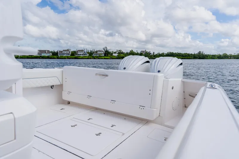  Yacht Photos Pics 2018 Intrepid 327 Center Console boat with dual engines on a calm lake.