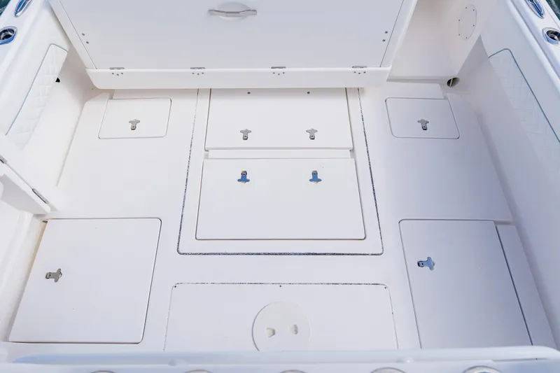  Yacht Photos Pics 2018 Intrepid 327 Center Console boat deck with multiple storage compartments.