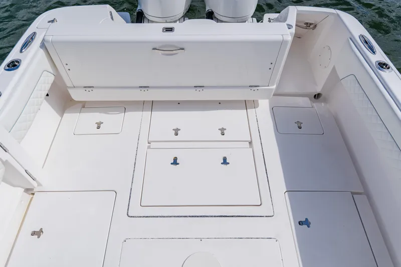  Yacht Photos Pics 2018 Intrepid 327 Center Console boat deck with storage compartments and seating.