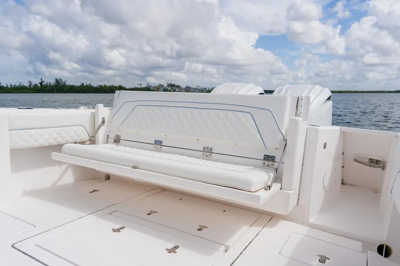  Yacht Photos Pics 2018 Intrepid 327 Center Console boat with foldable seating, on a calm water backdrop.