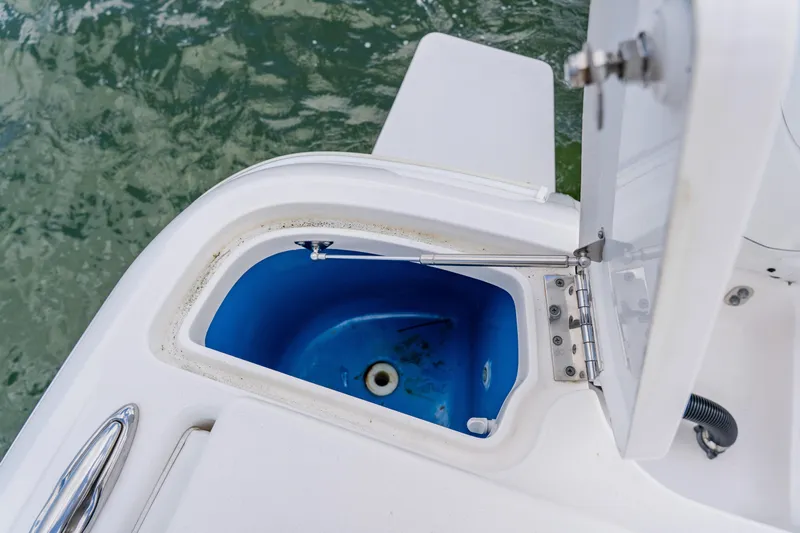  Yacht Photos Pics Open storage compartment on 2018 Intrepid 327 Center Console boat, near water.