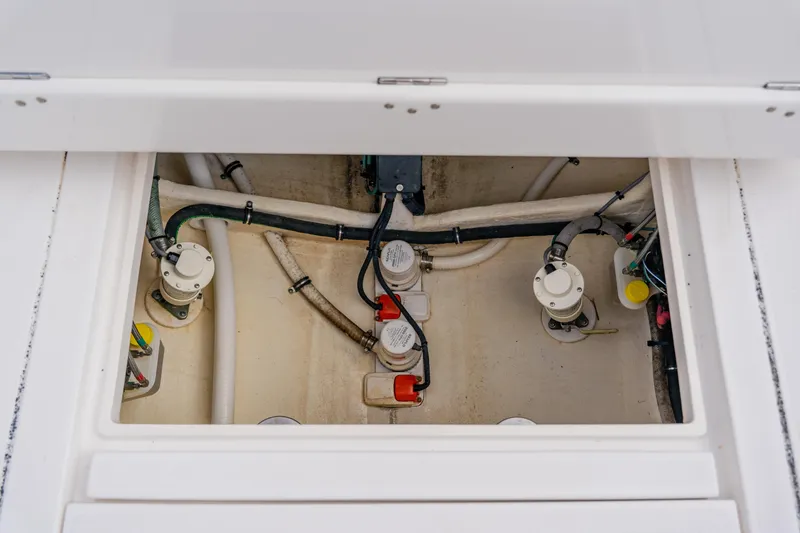  Yacht Photos Pics 2018 Intrepid 327 Center Console bilge area with pumps and hoses visible.
