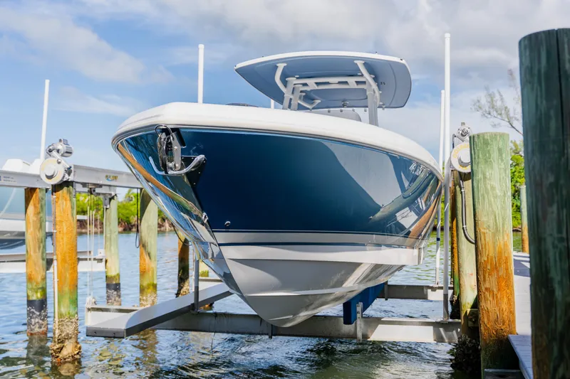  Yacht Photos Pics 2018 Intrepid 327 Center Console boat on lift at marina dock.