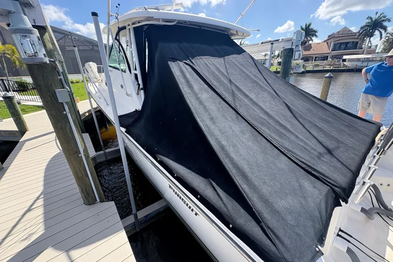 Happy Time 2 Yacht Photos Pics 2011 Pursuit OS 375 Offshore boat docked with black cover, sunny day, waterfront view.