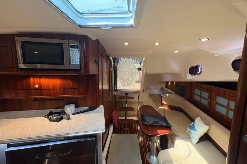 Happy Time 2 Yacht Photos Pics Luxurious interior of 2011 Pursuit OS 375 Offshore boat with modern amenities and seating.