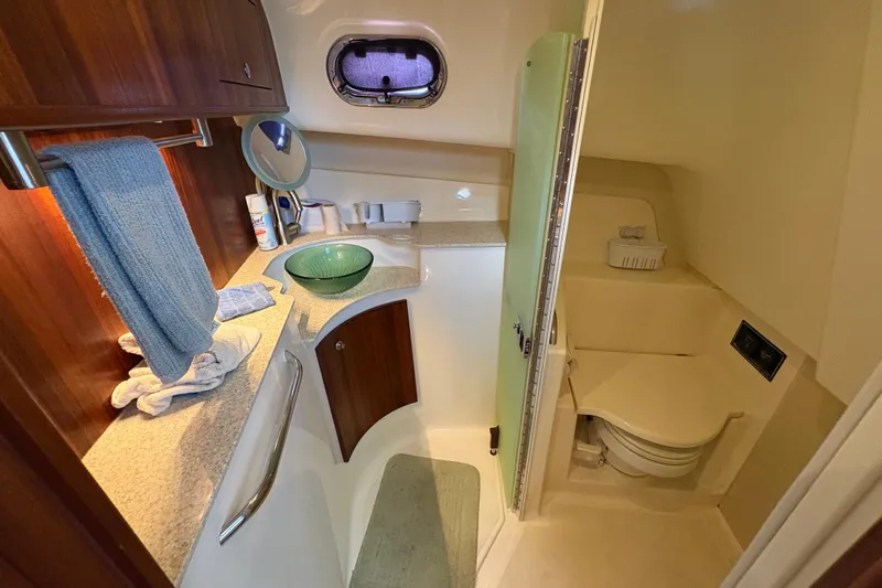 Happy Time 2 Yacht Photos Pics Luxurious bathroom in 2011 Pursuit OS 375 Offshore boat with modern amenities.