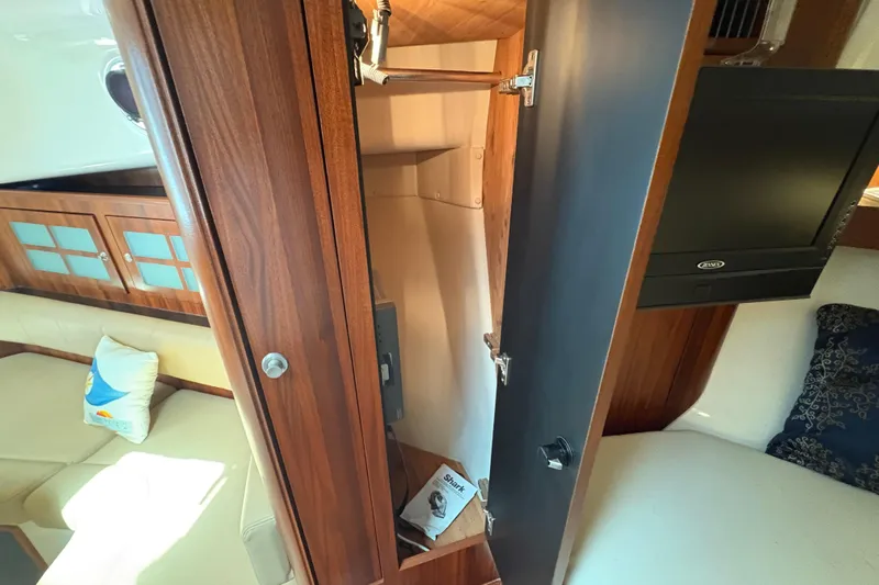 Happy Time 2 Yacht Photos Pics Interior of 2011 Pursuit OS 375 Offshore boat with wooden cabinetry and seating area.