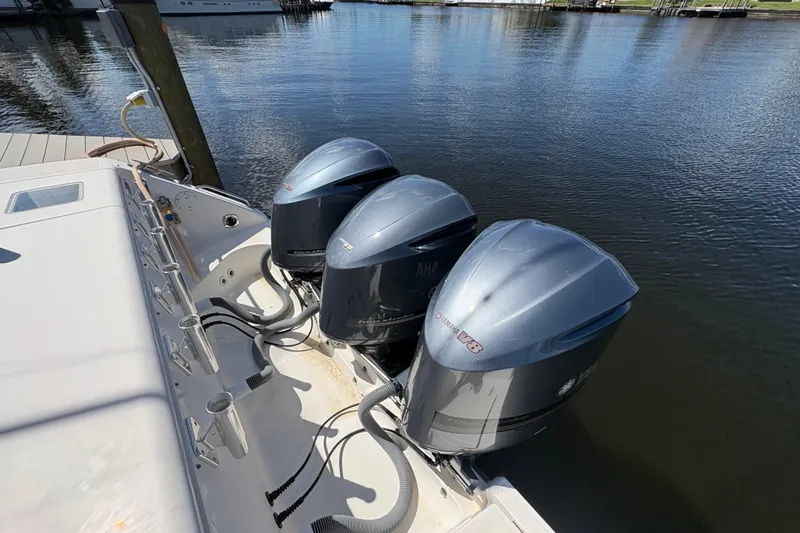 Happy Time 2 Yacht Photos Pics 2011 Pursuit OS 375 Offshore boat with triple Yamaha outboard engines docked by the water.