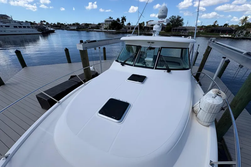 Happy Time 2 Yacht Photos Pics 2011 Pursuit OS 375 Offshore boat docked at marina under blue sky.