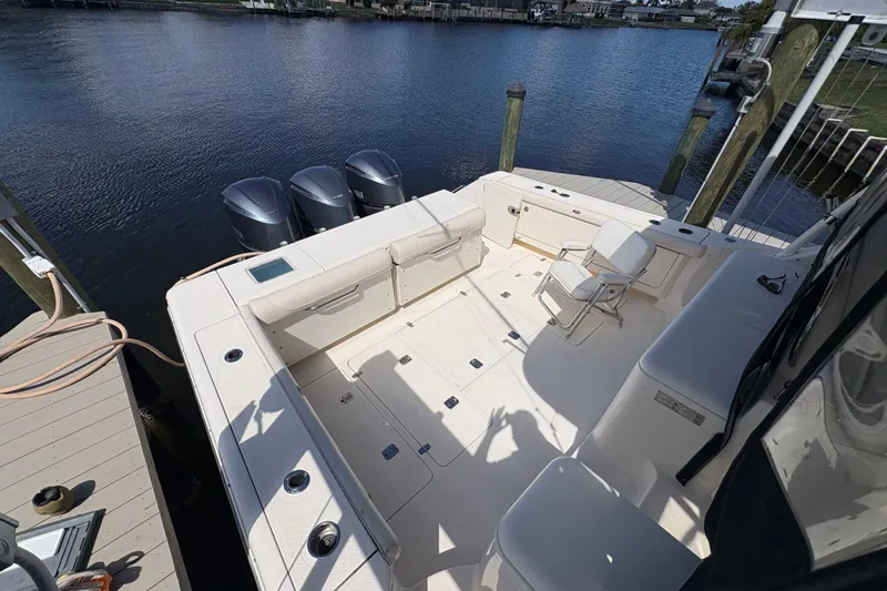 Happy Time 2 Yacht Photos Pics 2011 Pursuit OS 375 Offshore boat with triple outboard motors docked by the water.