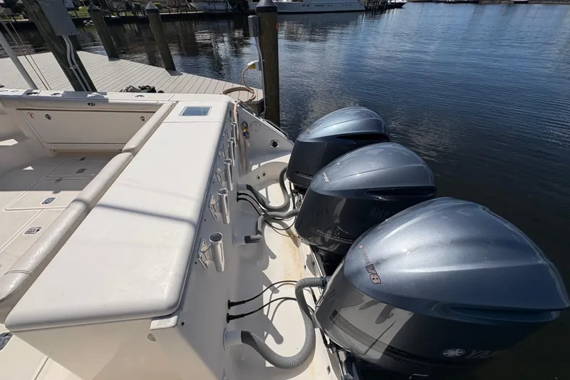 Happy Time 2 Yacht Photos Pics 2011 Pursuit OS 375 Offshore boat with triple Yamaha V8 engines docked by the water.