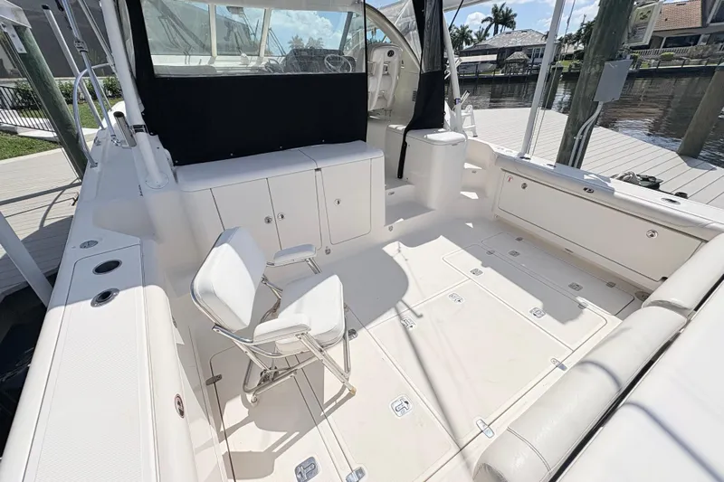 Happy Time 2 Yacht Photos Pics 2011 Pursuit OS 375 Offshore boat interior with seating and storage compartments.