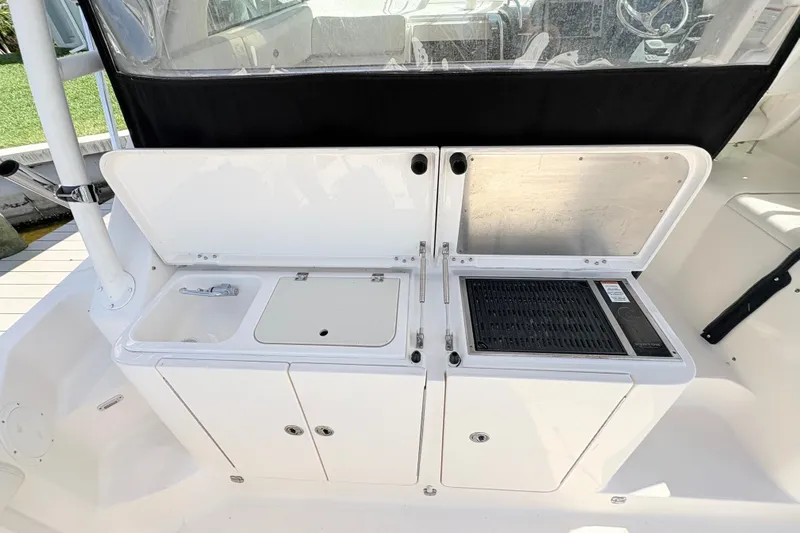 Happy Time 2 Yacht Photos Pics 2011 Pursuit OS 375 Offshore boat galley with sink and grill.