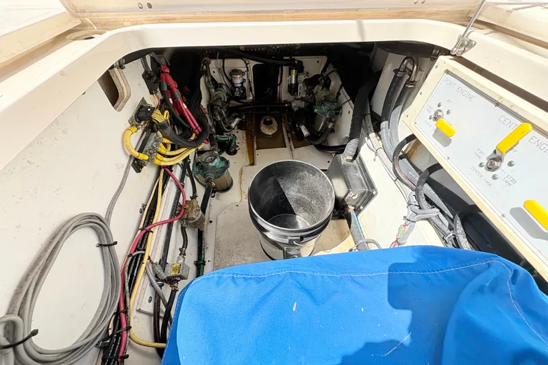 Happy Time 2 Yacht Photos Pics Engine compartment of a 2011 Pursuit OS 375 Offshore boat, showing wiring and controls.