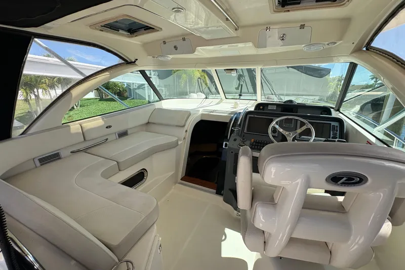 Happy Time 2 Yacht Photos Pics 2011 Pursuit OS 375 Offshore boat interior with helm, seating, and navigation equipment.