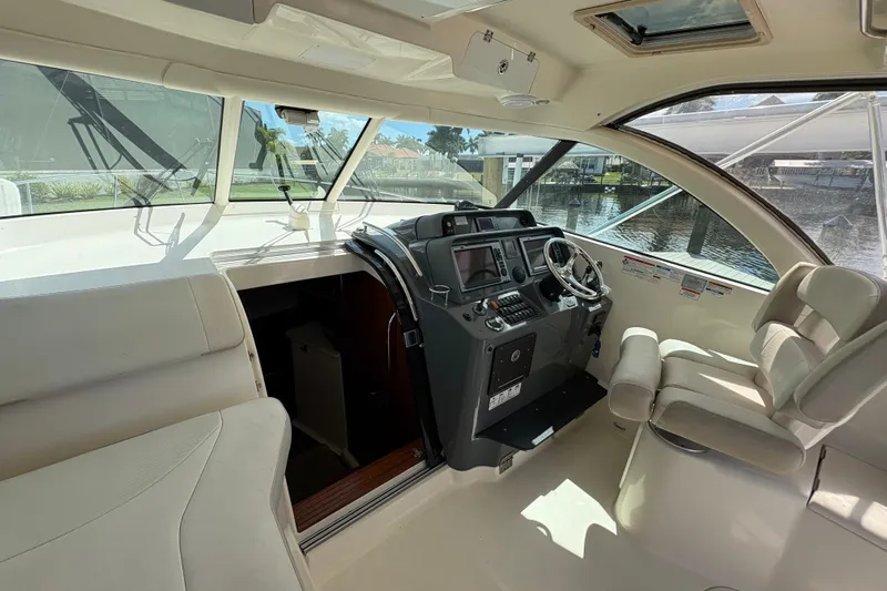 Happy Time 2 Yacht Photos Pics Interior of 2011 Pursuit OS 375 Offshore boat with helm and seating area.