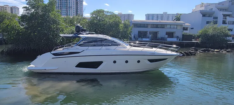  Yacht Photos Pics 2013 Azimut Atlantis 44 yacht on calm water near modern buildings.