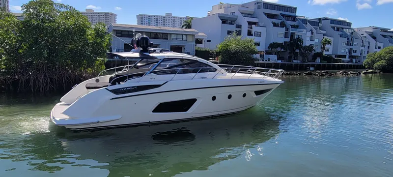  Yacht Photos Pics Azimut Atlantis 44 yacht, 2013 model, cruising near modern waterfront buildings.