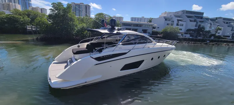  Yacht Photos Pics 2013 Azimut Atlantis 44 yacht cruising in a scenic waterfront setting.