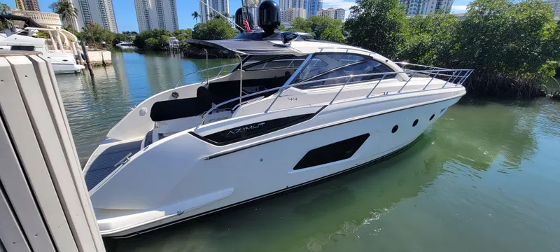  Yacht Photos Pics 2013 Azimut Atlantis 44 yacht docked in a serene marina setting.