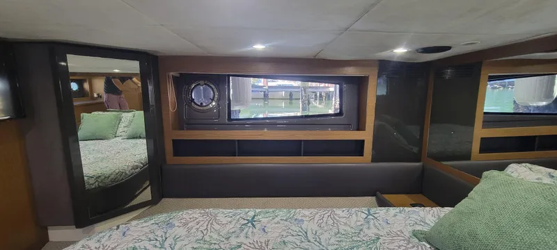  Yacht Photos Pics Interior of 2013 Azimut Atlantis 44 yacht bedroom with window and bedding.