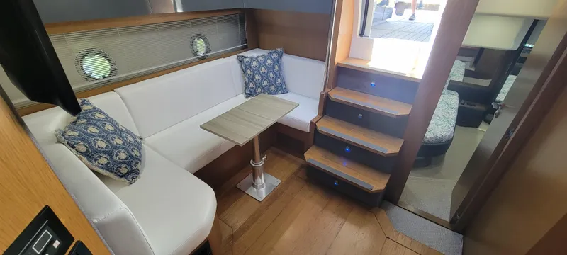  Yacht Photos Pics Interior of 2013 Azimut Atlantis 44 yacht with white seating and wooden stairs.