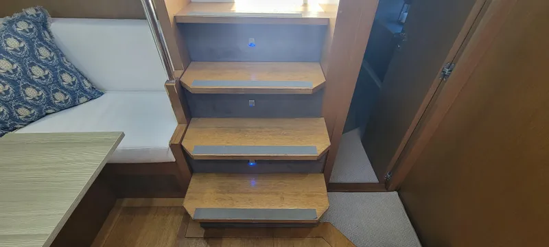  Yacht Photos Pics Interior stairs of 2013 Azimut Atlantis 44 yacht with wooden finish and ambient lighting.