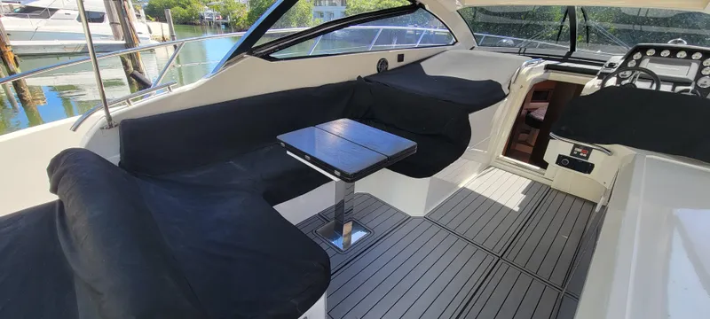  Yacht Photos Pics 2013 Azimut Atlantis 44 yacht interior with seating and table, docked by the water.