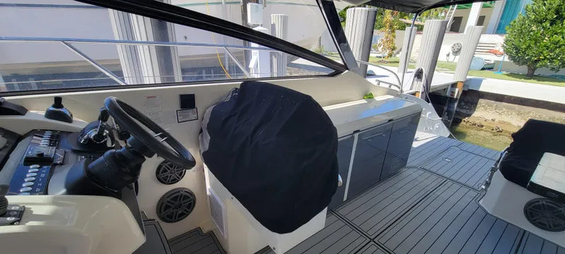  Yacht Photos Pics 2013 Azimut Atlantis 44 yacht cockpit with steering wheel and seating area.